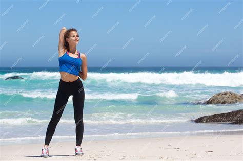 Premium Photo Healthy Young Woman Stretching At The Beach