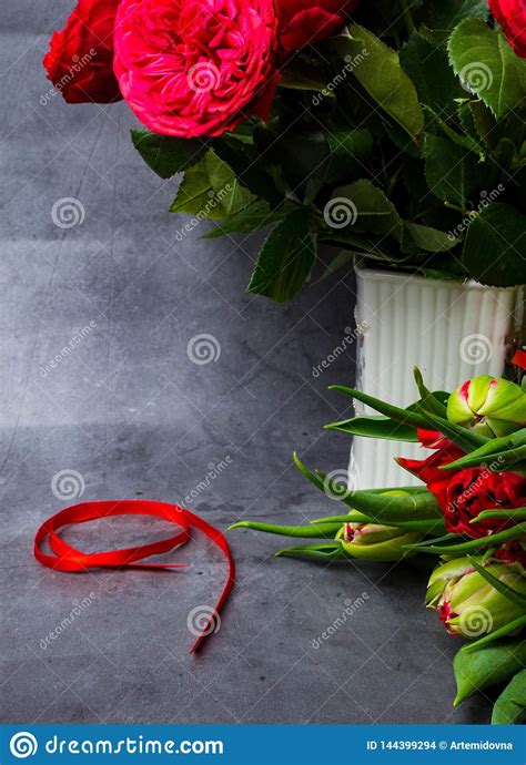 Red Tulips and Roses with Red Ribbon Isolated on Concrete Background ...