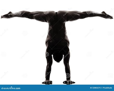 Handsome Naked Muscular Man Exercising Handstand Silhouette Stock Image