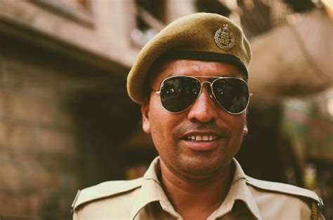 Close-Up Photo of a Police Officer Wearing Sunglasses · Free Stock Photo