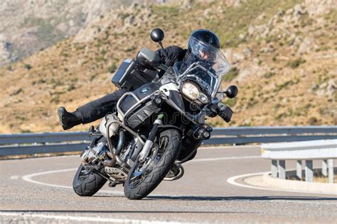 Motorcyclist Driving On The Road While Taking A Sharp Curve With His