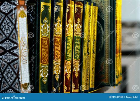 Holy Quran Books In A Row Standing On A Wooden Shelf Inside A Mosque