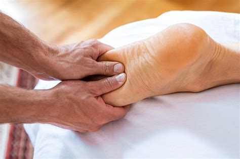 Premium Photo Cropped Hand Of Man Massaging Foot At Spa