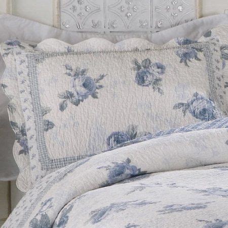 A White Bed With Blue Flowers On It