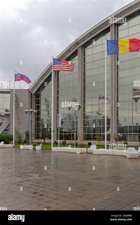 International Flags In Front Of Conference Centre Building Stock Photo