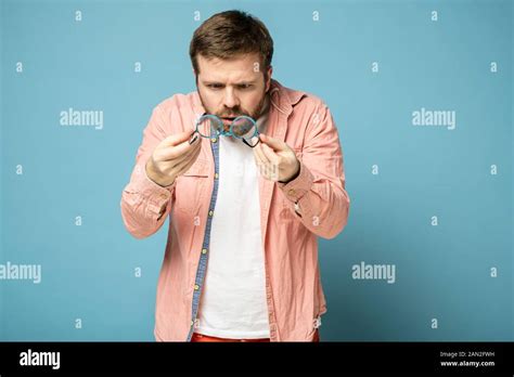 Shocked Strange Bearded Man Holds Glasses In Hands And Anxiously