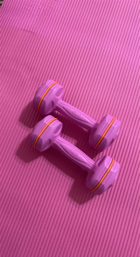 Two Purple Toy Cars Sitting On Top Of A Pink Mat