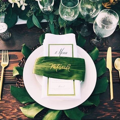 A Place Setting With Plates Silverware And Napkins On A Wooden Table