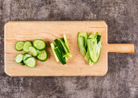 Free Photo Top View Cucumber Sliced On Wooden Cutting Board With Copy