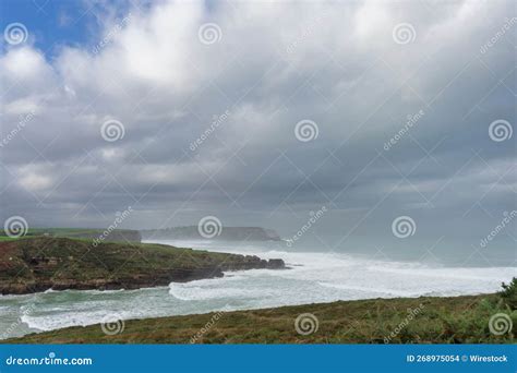 Beautiful Shot Of Foamy Sea Waves Covering Grass Fields Under A Cloudy