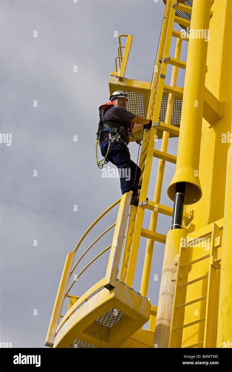 Maintenance engineer climbing tower of wind turbine of North Hoyle ...