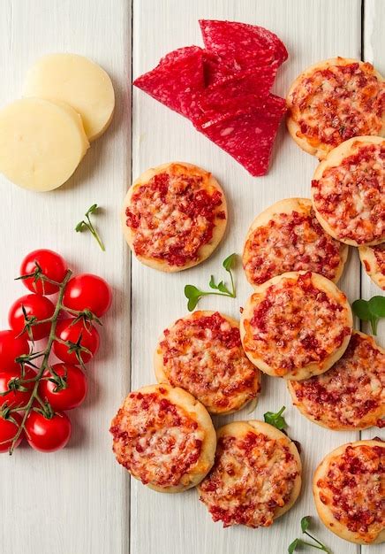 Premium Photo Mini Pizzas Salami With Mozzarella Cheese On A White