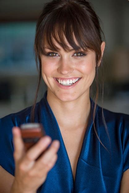 Premium Photo Portrait Of Smiling Woman Using Mobile Phone At Home