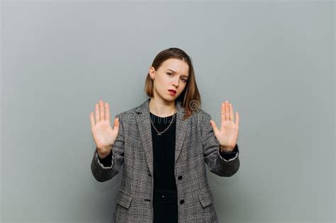 Business Woman In Jacket Showing Stop Gesture With Palms To Camera On