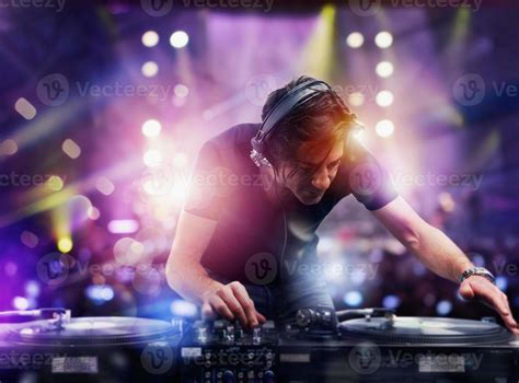 DJ playing music at the night discotheque 20556681 Stock Photo at Vecteezy