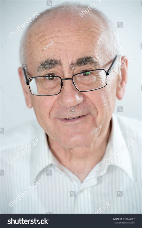 Portrait Of Old Smiling Man And Wearing Glasses On White Background