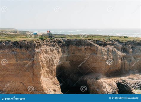 Dramatic Bluffs Cliffs Caves And Silhouette Of Walking People