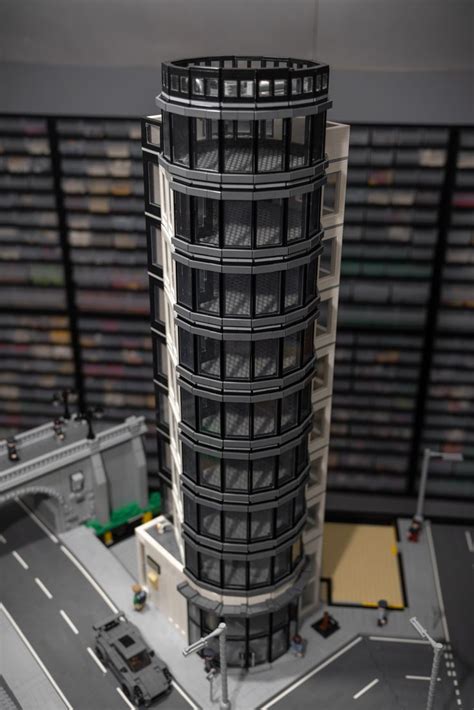 a model of a tall building with cars parked on the street in front of it