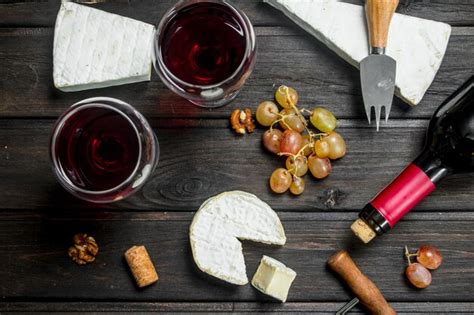 Premium Photo Brie Cheese With Red Wine Nuts And Grapes