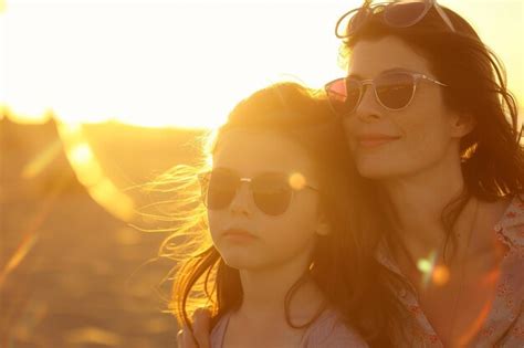 Premium Ai Image Mother And Daughter Enjoying Sunset At Beach With Ai