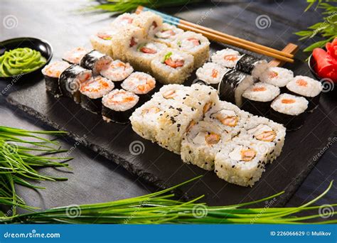 Conjunto De Rolos De Sushi Wasabi E Gengibre Sobre Fundo Preto