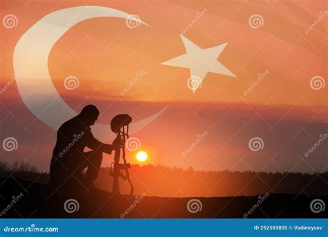 Silhouette Of Soldier Kneeling With His Head Bowed Against The Sunrise