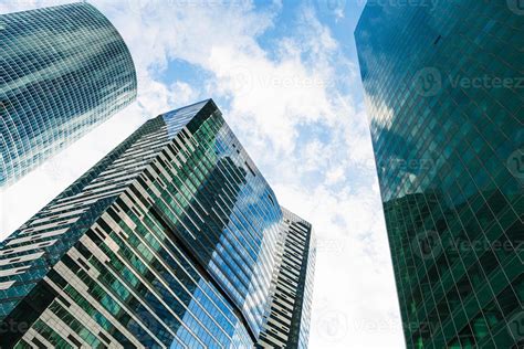 green skyscrapers under blue sky with white clouds 11462279 Stock Photo