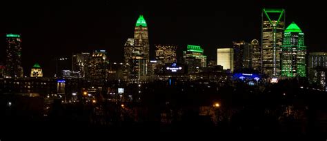 The Charlotte skyline lights up green in support as the Charlotte 49ers ...