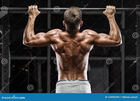 Muscular Man Doing Pull Up On Horizontal Bar In Gym Working Out Strong Fitness Male Showing