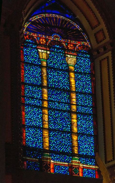 A Large Stained Glass Window Inside Of A Church With Blue And Yellow