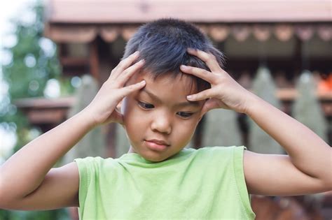 Premium Photo Alone Asian Little Boy Feel Sad Headache And Stressed