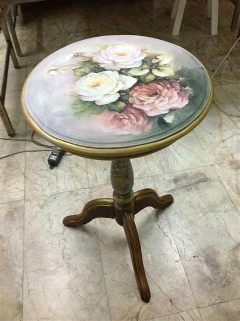 A Small Table With Flowers Painted On It