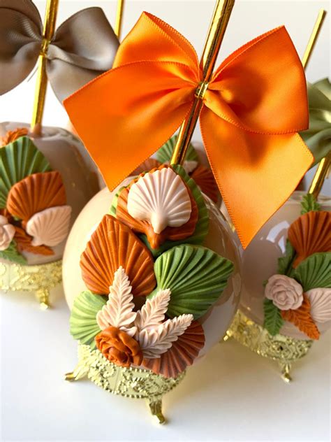 there are four candy apples with bows on top of each ornament in the ...