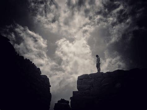 Premium Photo Low Angle View Of Silhouette Man Standing On Cliff