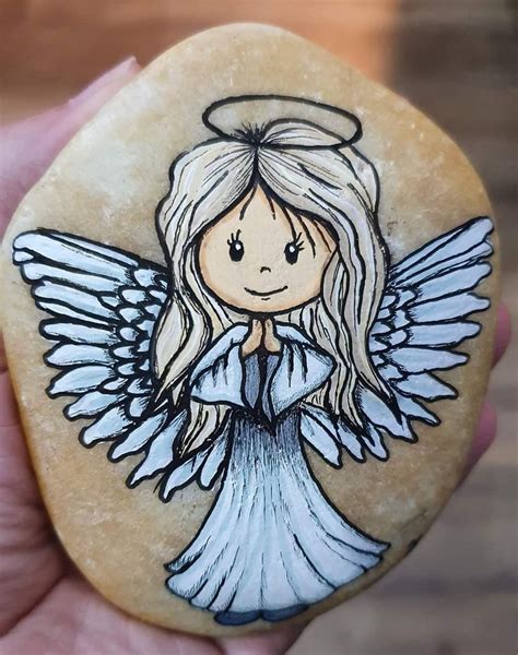 A Rock With An Angel Painted On It