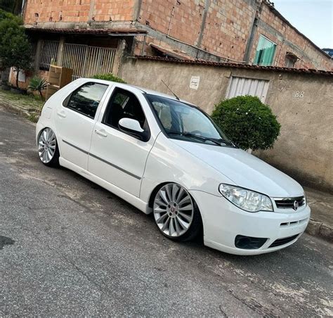 A White Car Parked In Front Of A Building