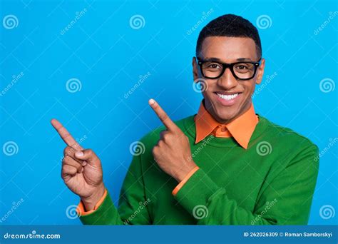 Portrait Of Clever Handsome Cheerful Guy Dressed Orange Shirt Under Green Pullover Directing