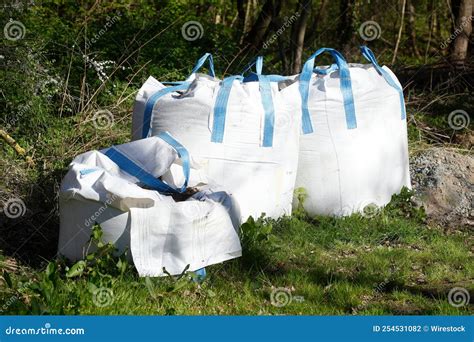 White Big Bulk Bags Full Of Potting Soil On The Grass Stock Photo