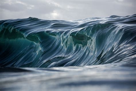 A jelly-like wave curls in multiple layers over a shallow reef on the ...