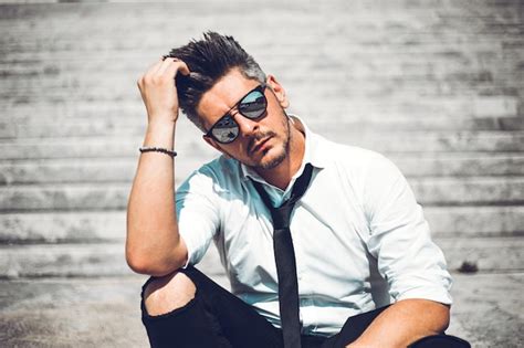 Premium Photo Midsection Of Man Wearing Hat While Standing Against Wall