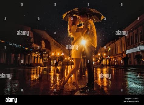 Love In The Rain Silhouette Of Kissing Couple Under Umbrella Stock