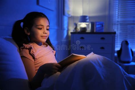 Little Girl Reading Fairy Tale in Dark Bedroom Stock Photo - Image of light, lifestyle: 214012446