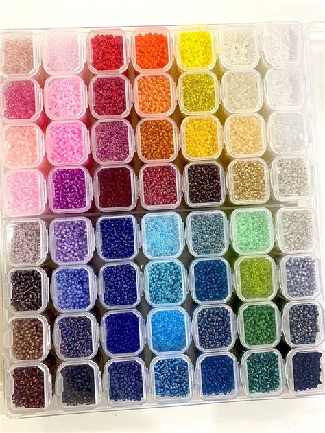 Many Different Colors Of Beads In Plastic Containers