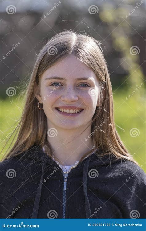 Portrait Of A Beautiful Happy Girl With Blond Hair And Freckles Looking