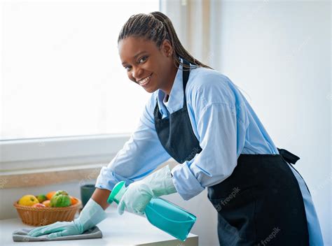 Premium Photo Positive African American Maid Cleaning Kitchen And Smiling