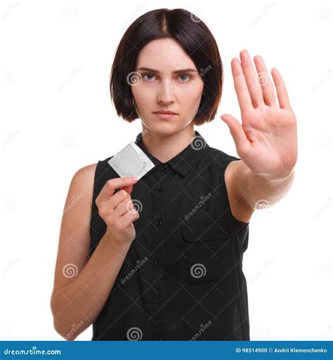 Aware Young Woman Showing A Condom Or Contraceptive Isolated On A White