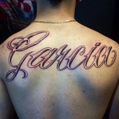 A Man With A Tattoo On His Back That Says Fearless In Cursive Writing