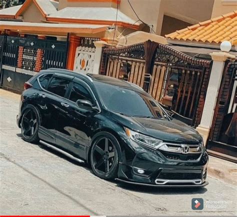 A Black Car Parked In Front Of A Building