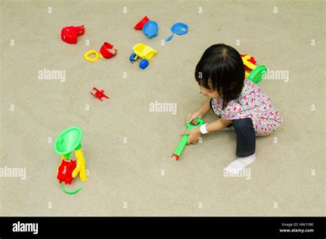 Asian Chinese Little Girl Playing Sand At Indoor Playground Stock Photo