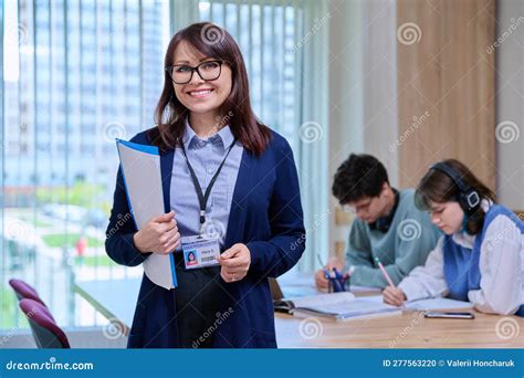 Portrait Of Middle Aged Female Teacher Looking At Camera In College